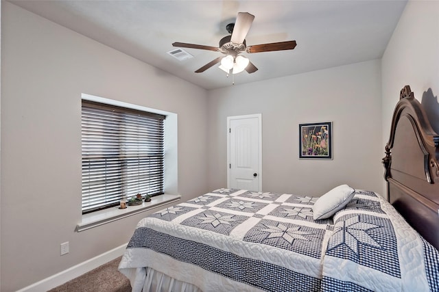 carpeted bedroom with visible vents, ceiling fan, and baseboards