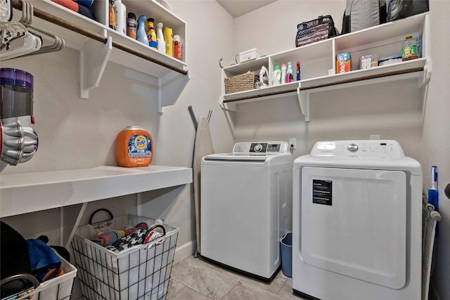 washroom with washing machine and clothes dryer and laundry area