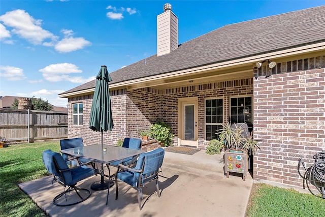 view of patio / terrace with outdoor dining area and fence