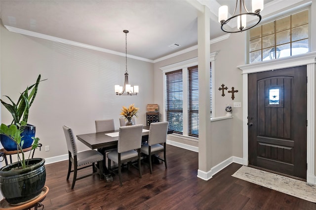 entrance foyer with baseboards, dark wood-type flooring, an inviting chandelier, and ornamental molding