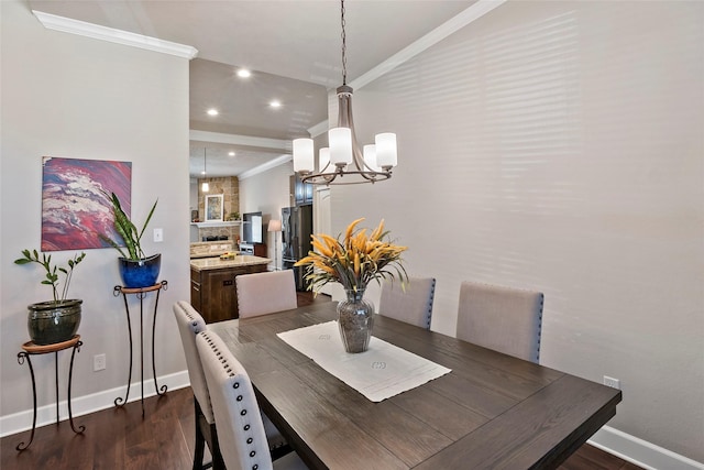 dining space with dark wood-type flooring, baseboards, a chandelier, ornamental molding, and recessed lighting