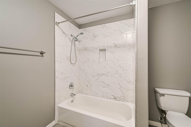 bathroom with toilet, shower / bathing tub combination, and baseboards