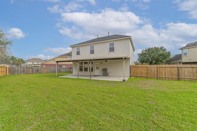 rear view of property with a yard, a fenced backyard, and a patio area