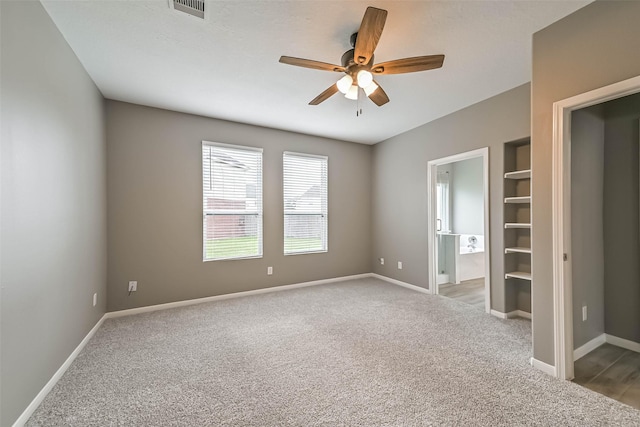 unfurnished bedroom featuring carpet flooring, visible vents, and baseboards