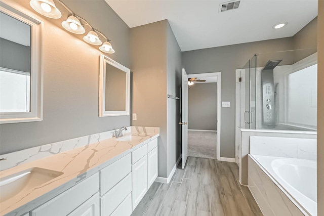 bathroom featuring a shower stall, a bath, visible vents, and a sink