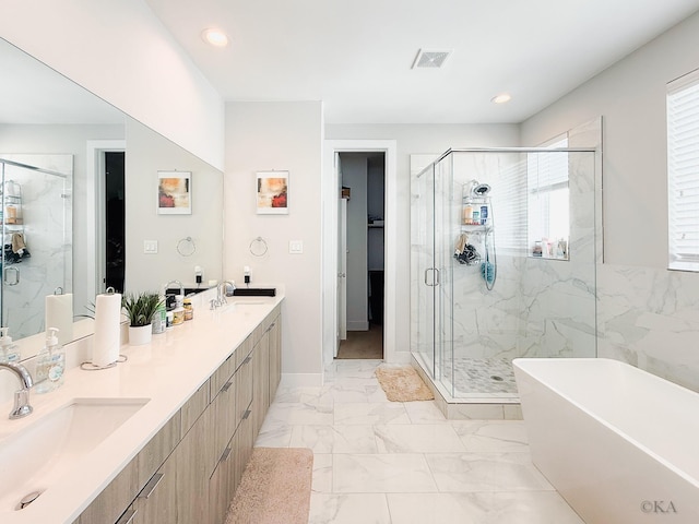 full bathroom featuring visible vents, a freestanding tub, a sink, a shower stall, and marble finish floor