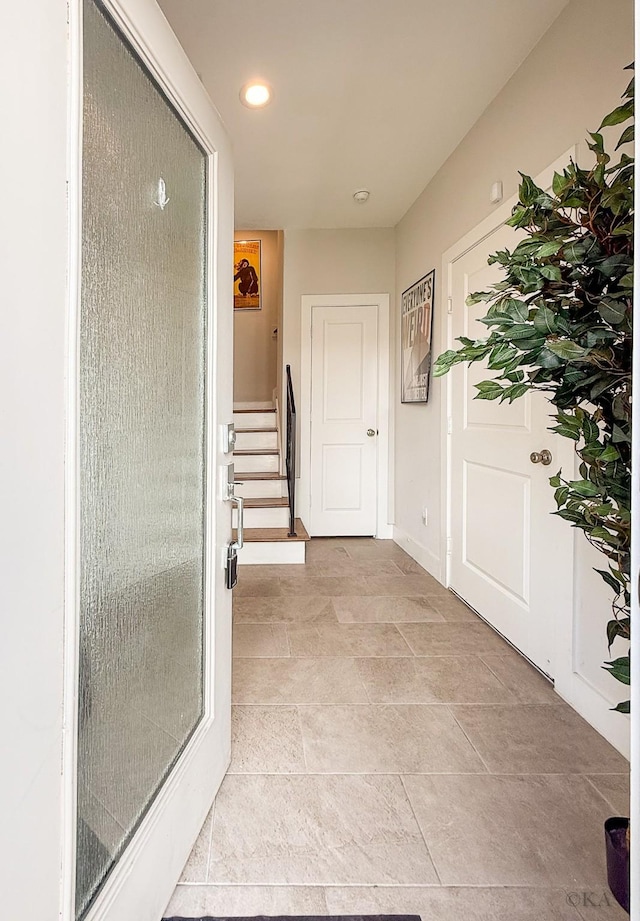 hall featuring recessed lighting, stairway, and baseboards