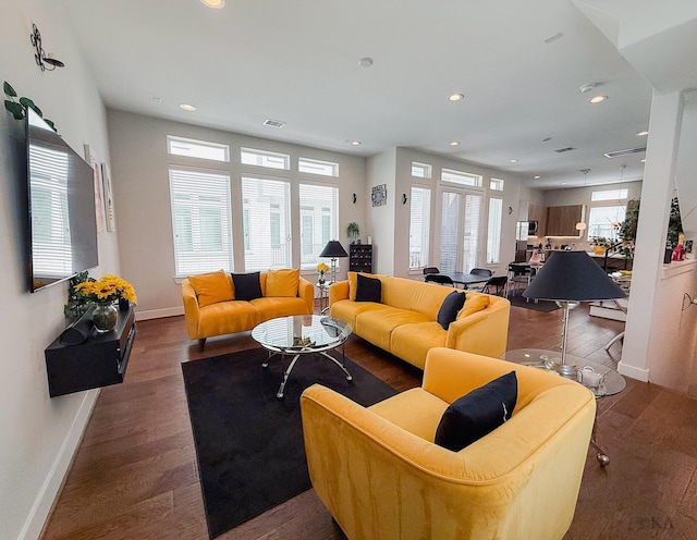 living area with recessed lighting, baseboards, and wood finished floors