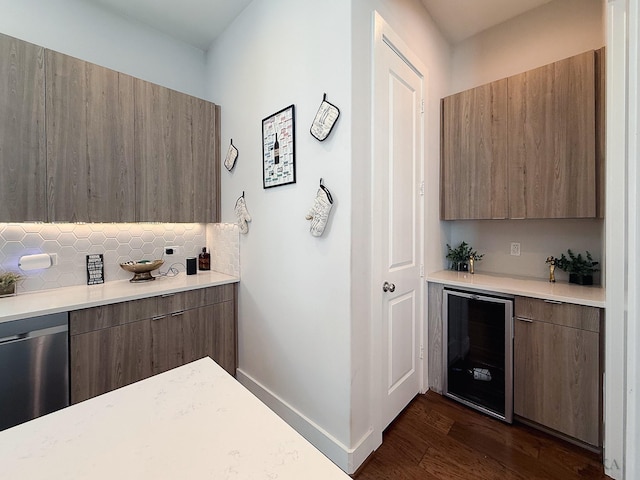 bar featuring tasteful backsplash, wine cooler, baseboards, dishwasher, and dark wood-style flooring