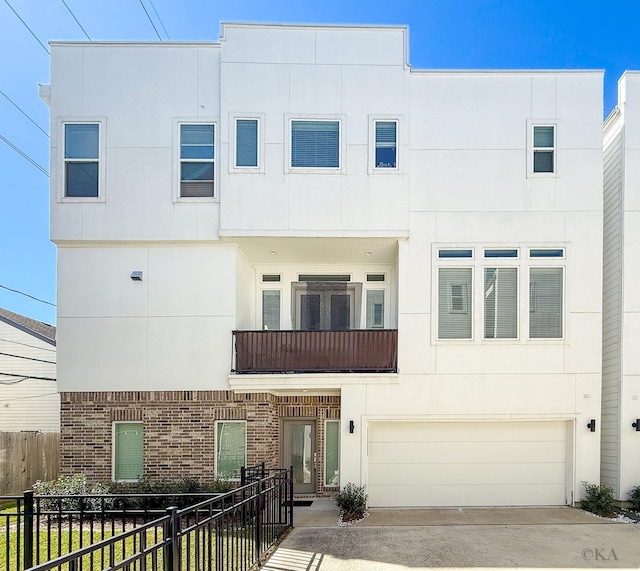 view of front facade featuring brick siding, stucco siding, driveway, and fence