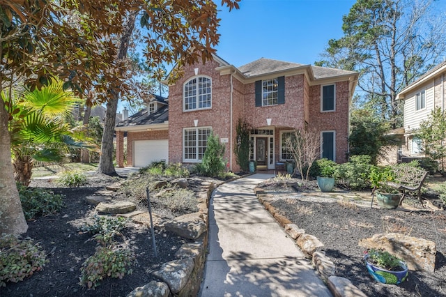 view of front of home featuring brick siding and a garage