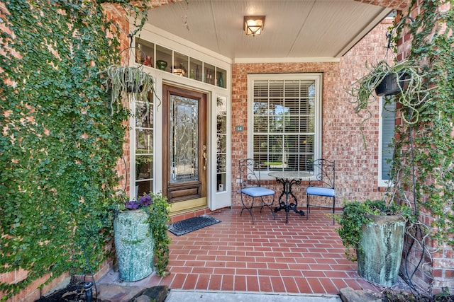 entrance to property featuring brick siding