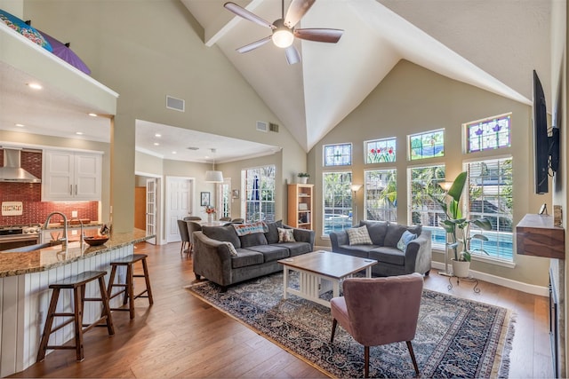 living room featuring visible vents, wood-type flooring, and baseboards