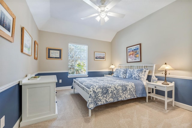 bedroom featuring baseboards, light carpet, a ceiling fan, and vaulted ceiling