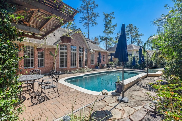 outdoor pool with outdoor dining space, a pergola, and a patio area