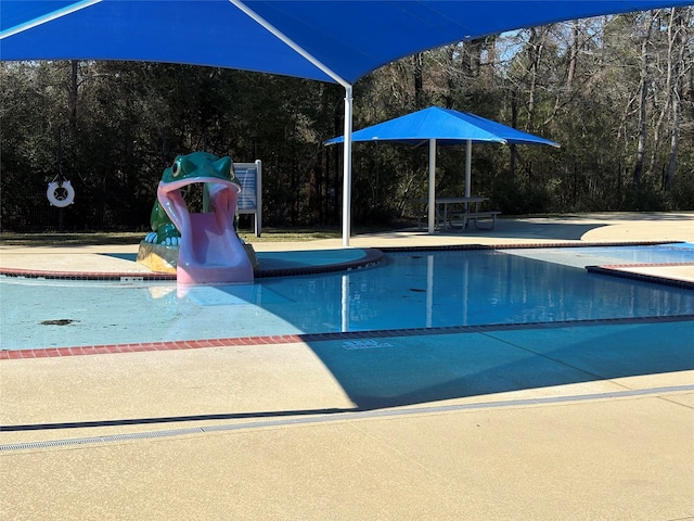 view of pool with a wooded view