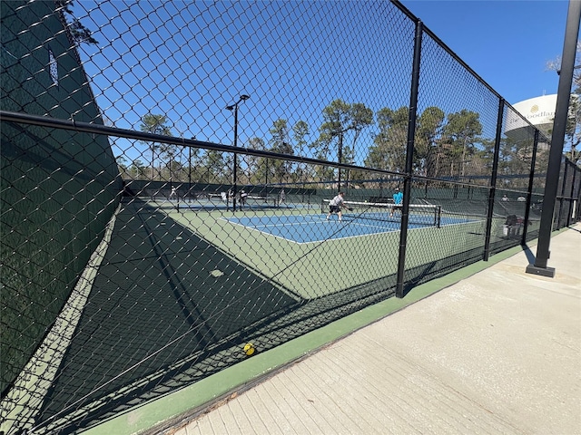 view of tennis court with fence