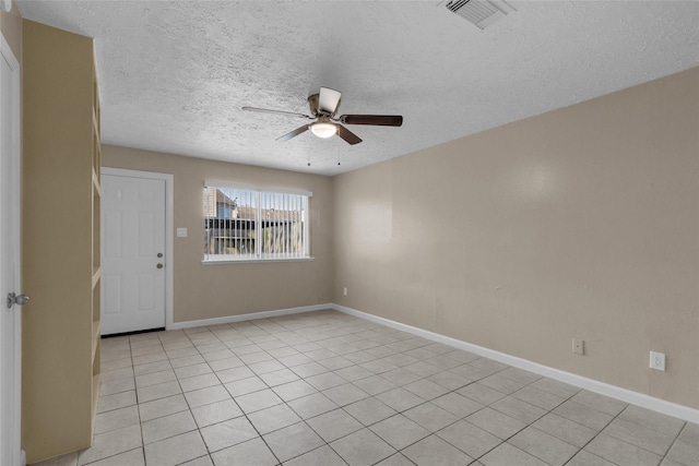 empty room with light tile patterned floors, baseboards, visible vents, ceiling fan, and a textured ceiling