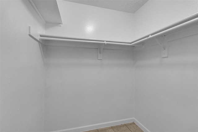 spacious closet featuring light tile patterned flooring