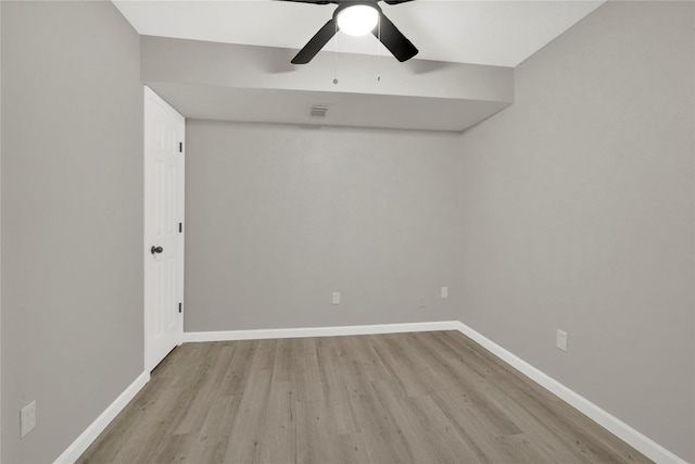 empty room with visible vents, ceiling fan, baseboards, and wood finished floors