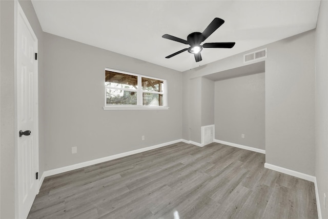 unfurnished room with visible vents, baseboards, light wood-style floors, and ceiling fan