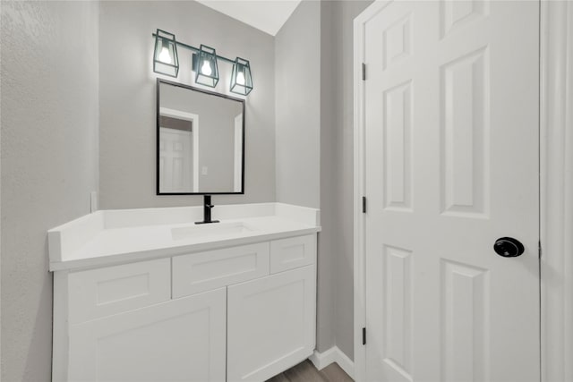 bathroom with vanity and baseboards