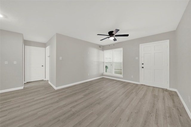 empty room with ceiling fan, baseboards, and light wood-style flooring