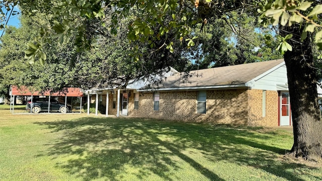 back of property featuring a lawn