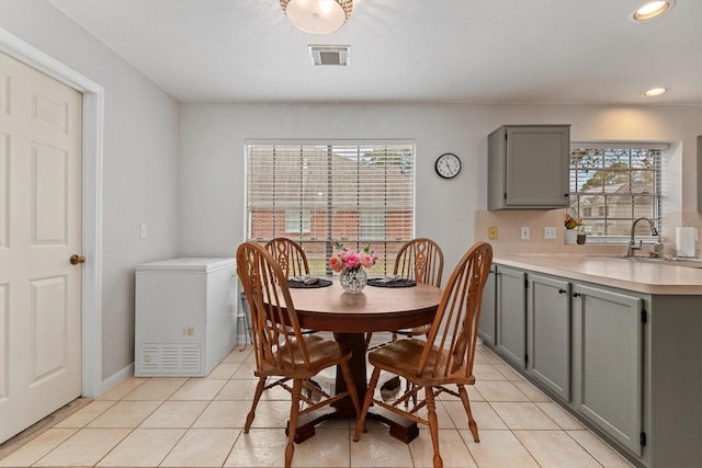 dining space with recessed lighting, visible vents, a healthy amount of sunlight, and light tile patterned floors