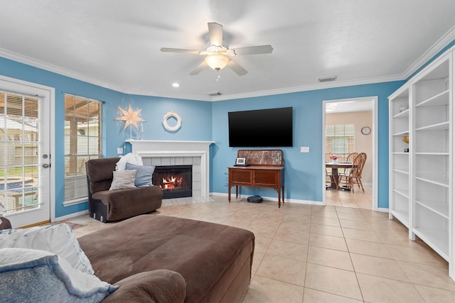 living room with light tile patterned floors, visible vents, plenty of natural light, and crown molding