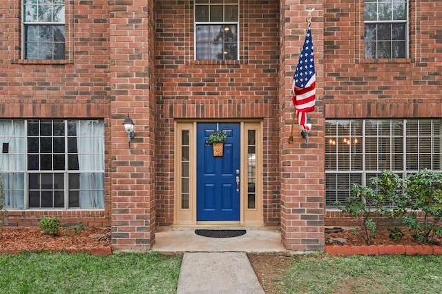 property entrance with brick siding