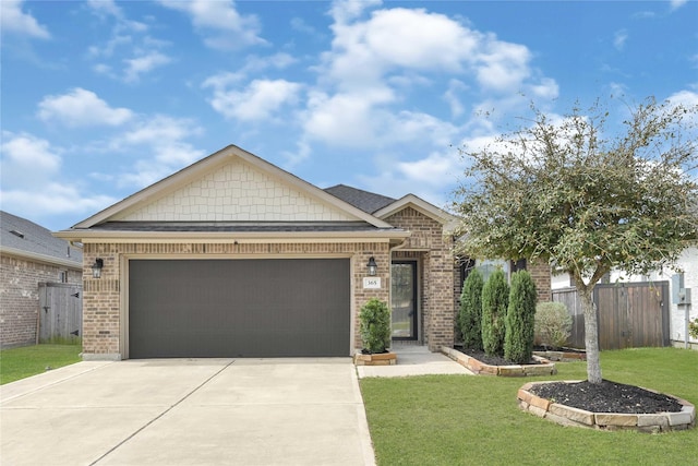 view of front facade with brick siding, driveway, a front lawn, and fence