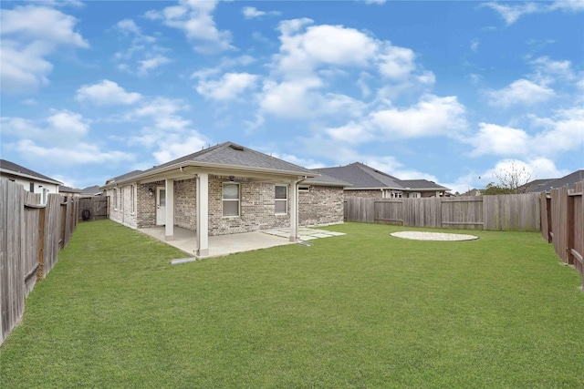 view of yard featuring a patio area and a fenced backyard