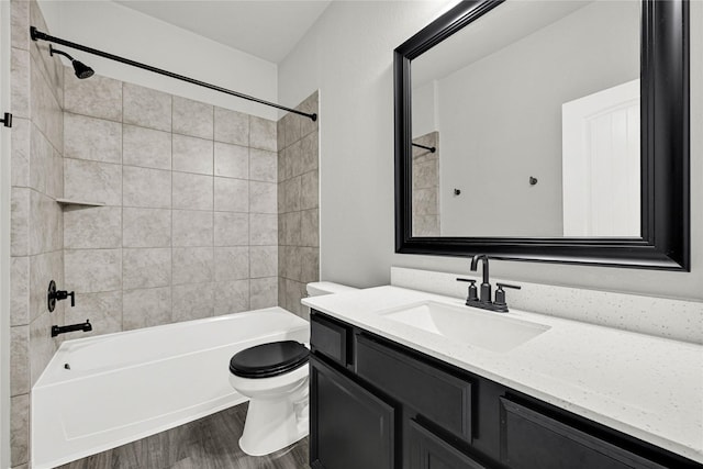 full bathroom featuring toilet,  shower combination, wood finished floors, and vanity