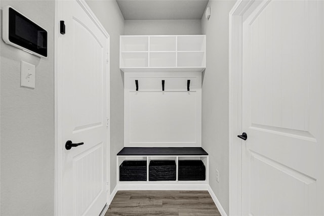 mudroom with baseboards and wood finished floors