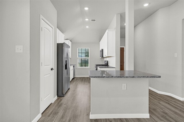 kitchen featuring wood finished floors, baseboards, visible vents, stainless steel appliances, and white cabinets