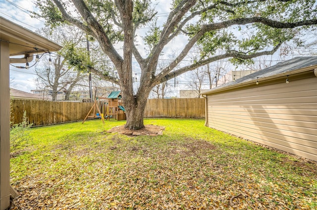 view of yard with a fenced backyard and a playground