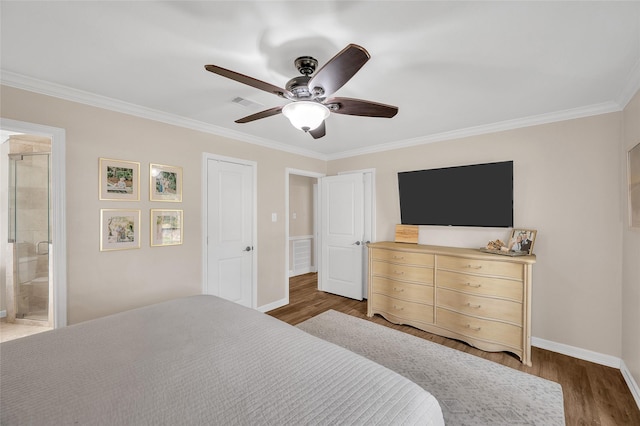 bedroom with visible vents, baseboards, ornamental molding, wood finished floors, and a ceiling fan