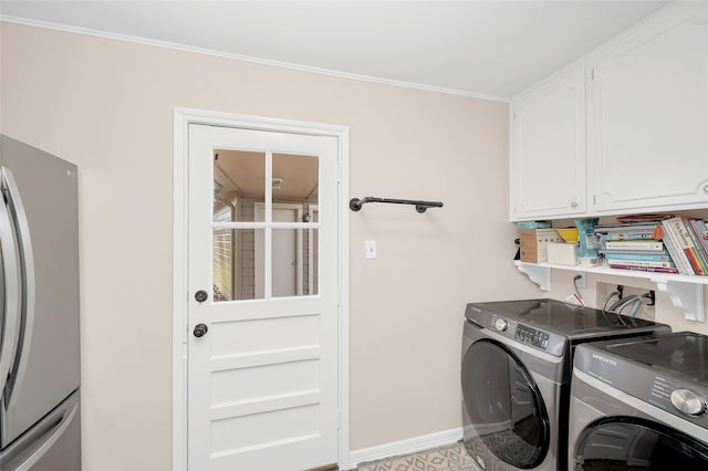 laundry area featuring cabinet space, washer and dryer, baseboards, and ornamental molding