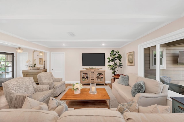 living area with wood finished floors, visible vents, baseboards, recessed lighting, and ornamental molding