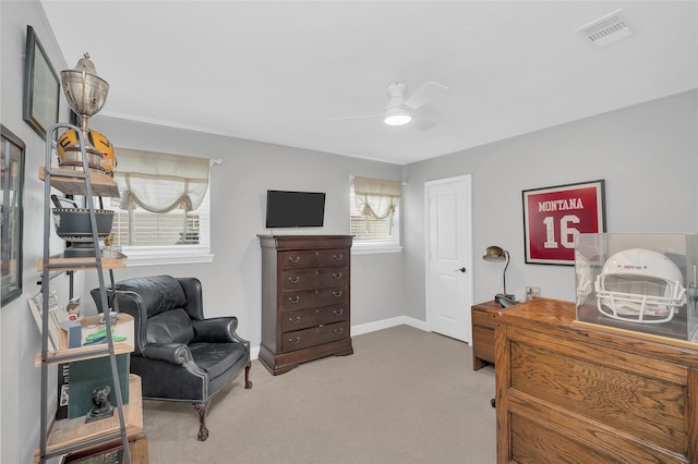 interior space featuring visible vents, baseboards, carpet, and a ceiling fan