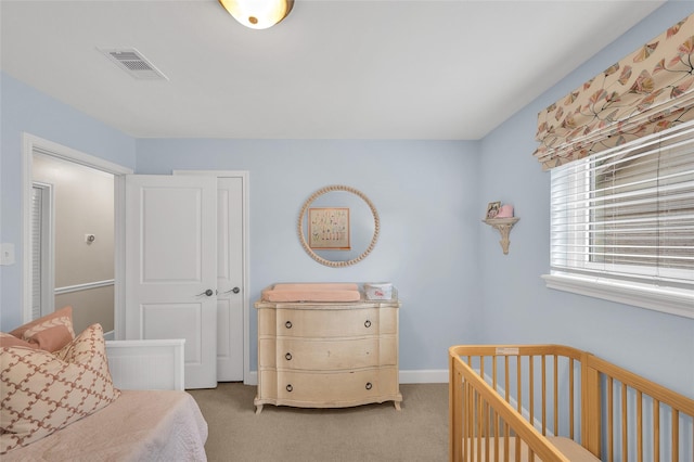 bedroom with carpet, visible vents, a closet, and baseboards