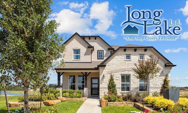 view of front of house featuring stone siding and a shingled roof