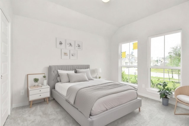 bedroom featuring light carpet, baseboards, and lofted ceiling