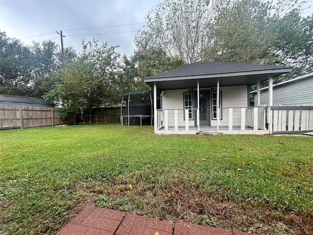 exterior space featuring a trampoline and fence