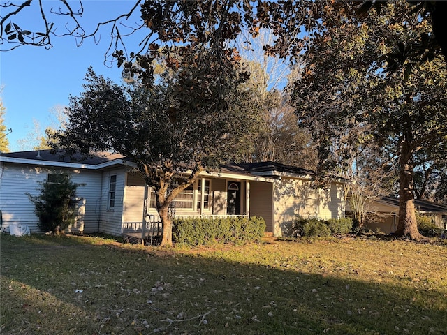 rear view of house featuring a lawn