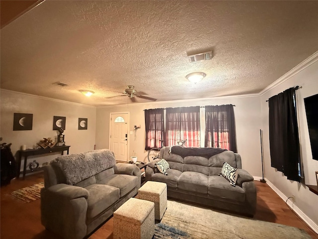 living area with visible vents, ceiling fan, dark wood-type flooring, a textured ceiling, and crown molding