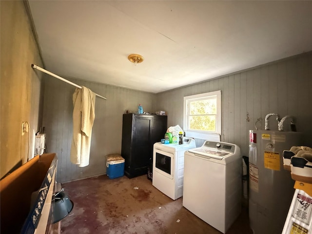 laundry area with water heater, laundry area, and washer and clothes dryer