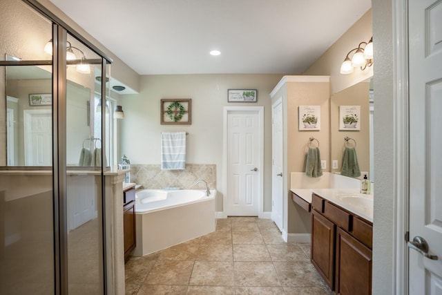 bathroom with tile patterned flooring, baseboards, a stall shower, a bath, and vanity