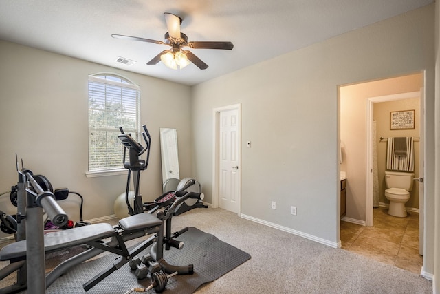 exercise area featuring visible vents, carpet flooring, baseboards, and ceiling fan